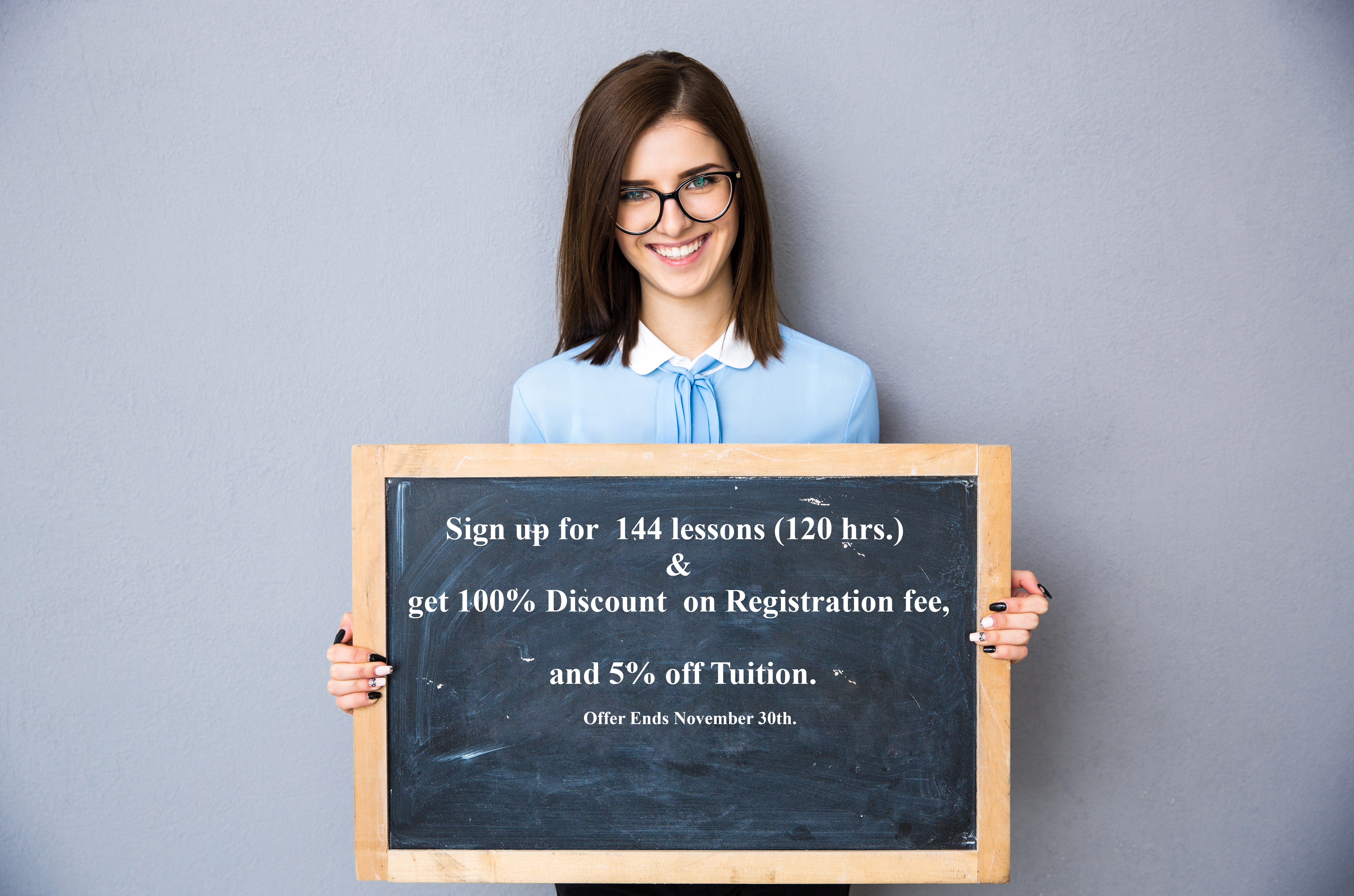 Smiling woman standing with billboard over gray background Smiling woman standing with billboard over gray background