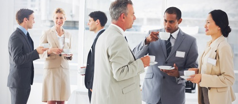 Business people chatting and drinking coffee at a conference Business people chatting and drinking coffee at a conference