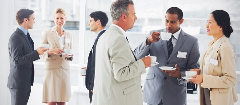 Business people chatting and drinking coffee at a conference